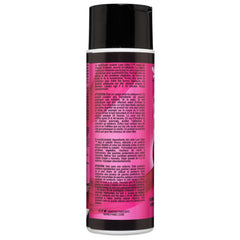 A close-up photo of the back label of a black and pink Manic Panic® LOVE COLOR™ FUCHSIA FEVER CONDITIONER bottle, featuring detailed ingredient information and usage instructions in small white text.