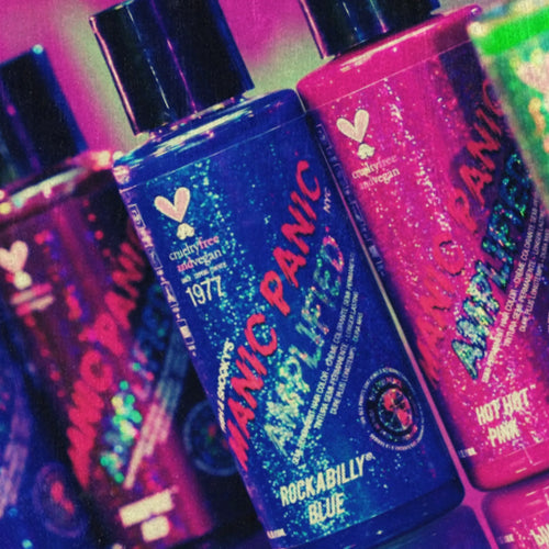 Manic Panic semi-permanent hair dye bottles in Rockabilly Blue, Hot Hot Pink, purple, and green shades under vibrant neon lighting.