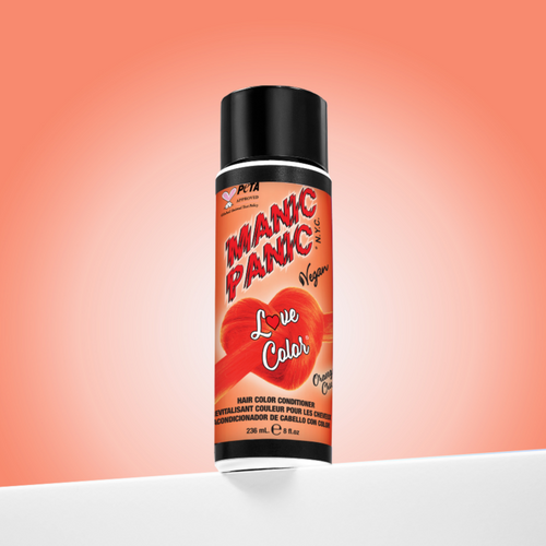 A bottle of Manic Panic® LOVE COLOR™ ORANGE CRUSH® conditioner. The packaging features red and blue graphics with text emphasizing the vegan formulation.