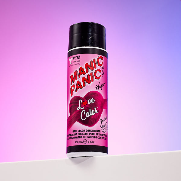A bottle of Manic Panic® LOVE COLOR™ FUCHSIA FEVER® conditioner. The packaging features red and blue graphics with text emphasizing the vegan formulation.