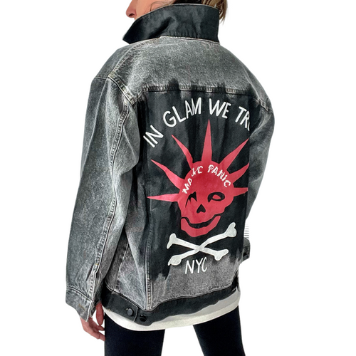 WOMAN WEARING A HAND PAINTED WREN AND GLORY DENIM JACKET WITH THE MANIC PANIC LOGO AND SKULLY LOGO