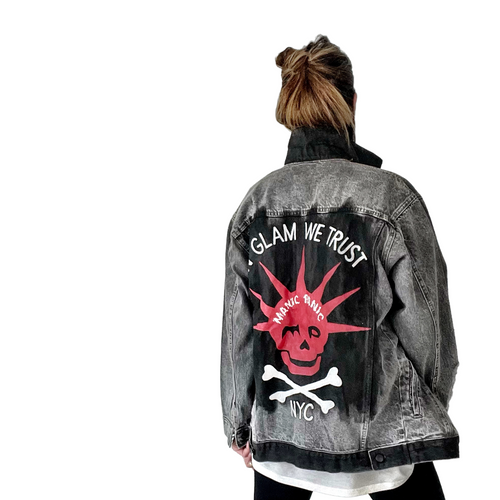 WOMAN WEARING A HAND PAINTED WREN AND GLORY DENIM JACKET WITH THE MANIC PANIC LOGO AND SKULLY LOGO