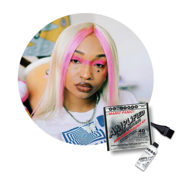 A circular inset shows a woman with long platinum-blonde hair featuring bright pink streaks, wearing makeup and jewelry, while the main image displays a Manic Panic Amplified Hair bleachr Kit bottle and applicatorbrush on a white background.