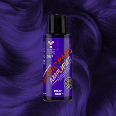 Manic Panic Amplified Violet Night hair dye bottle on deep purple wavy hair background