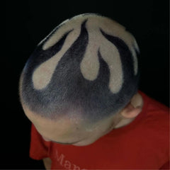 Buzzcut flame hair design featuring black and bleached contrast in a bold barber pattern   styled with Manic Panic® C Amplified Raven Hair Dye. Creative scalp art viewed from above, showcasing edgy, high-contrast flames.