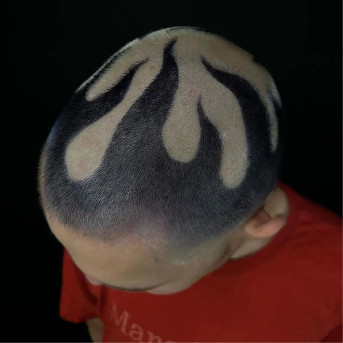 Buzzcut flame hair design featuring black and bleached contrast in a bold barber pattern   styled with Manic Panic® C Amplified Raven Hair Dye. Creative scalp art viewed from above, showcasing edgy, high-contrast flames.