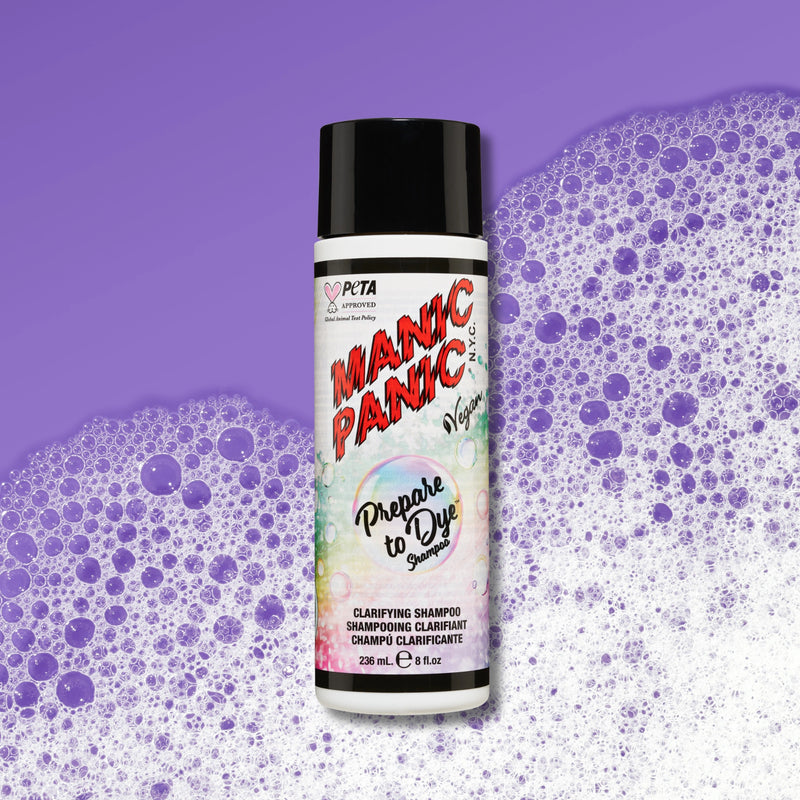 A bottle of PETA Certified Vegan Manic Panic Prepare to Dye Shampoo centered against a purple background with purple and white foam bubbles.