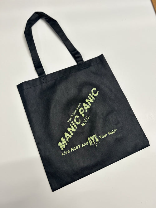 Black  In Glam We Trust Manic Panic reusable tote bag with Skully logo in varying colors